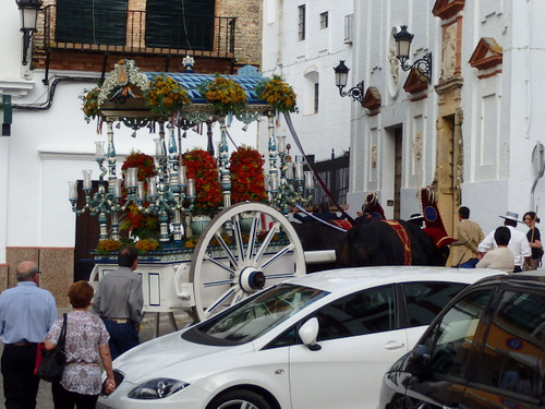 Some sort of Ox Cart Prosession and Ceremony is taking place.